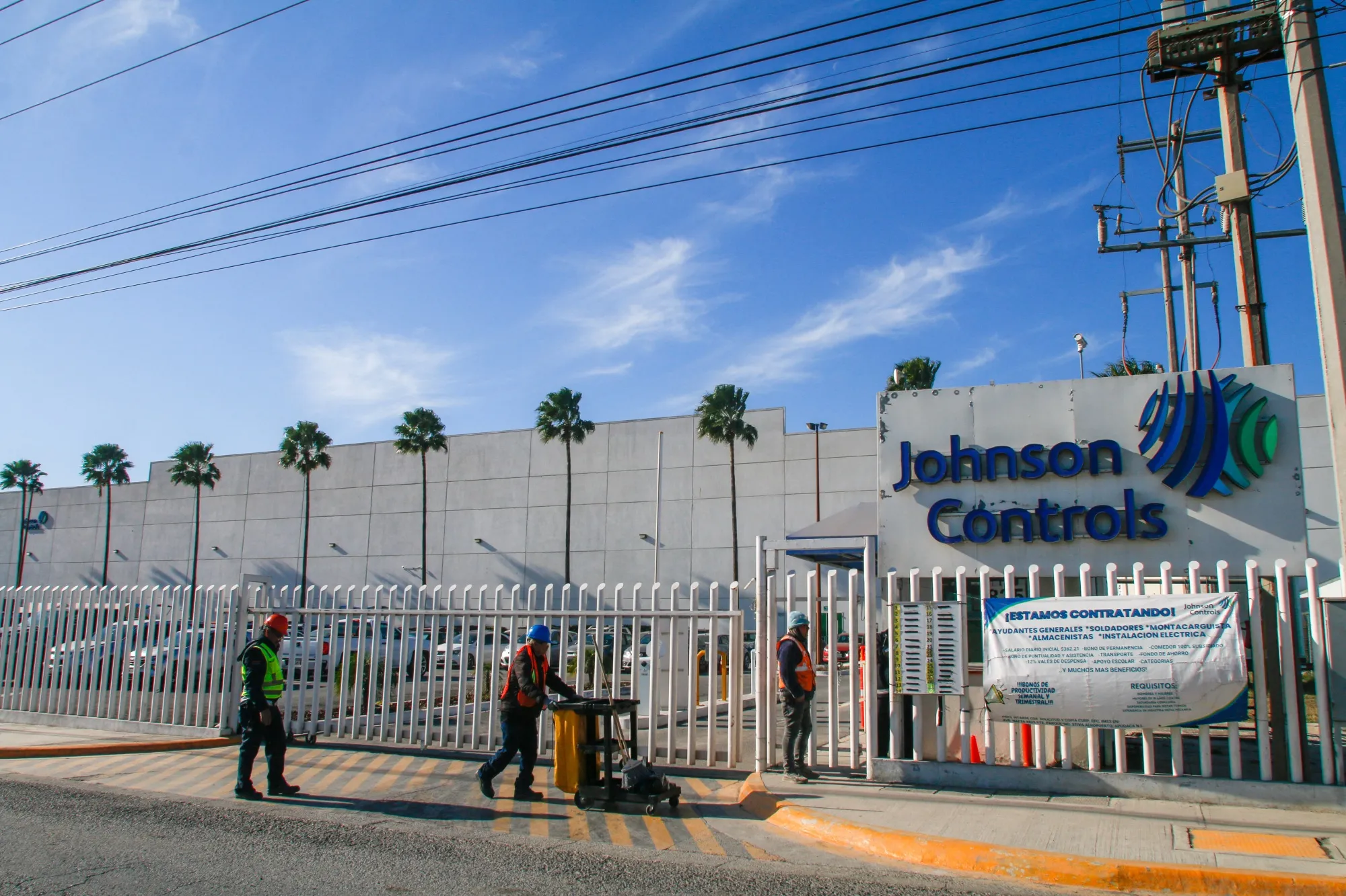 Workers enter a Johnson Controls company plant.