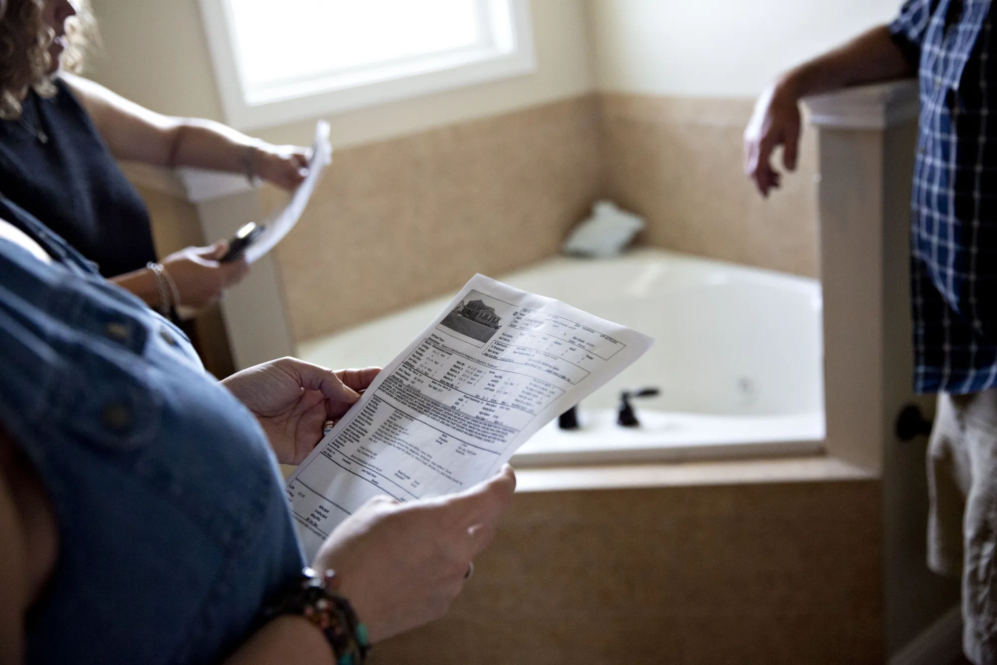 A prospective home buyer views the spec sheet of a house for sale in Dunlap, Illinois, on&nbsp;Aug. 19.&nbsp;