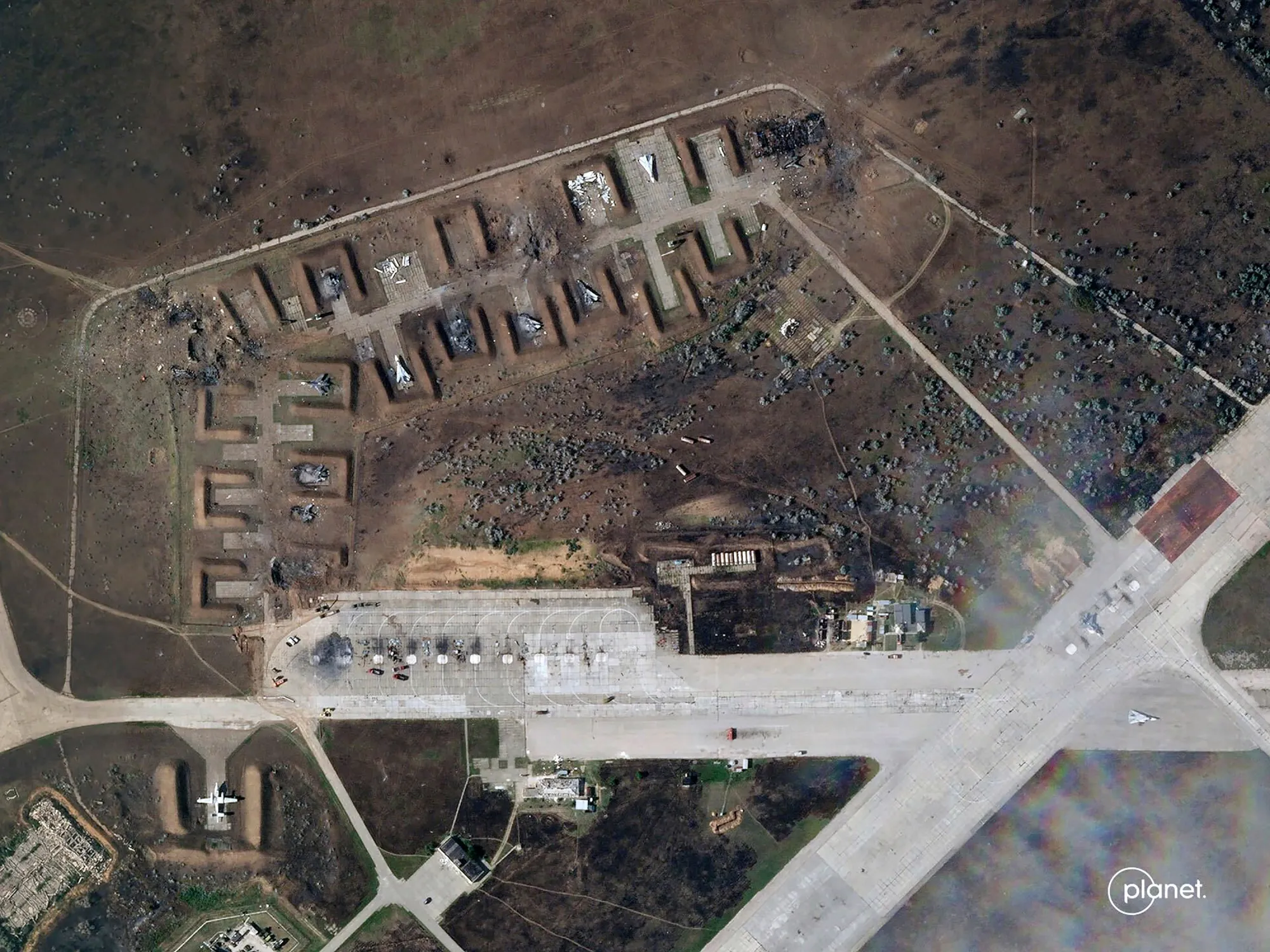 A satellite image provided by Planet Labs PBC shows destroyed Russian aircraft at Saky Air Base after an explosion Tuesday.