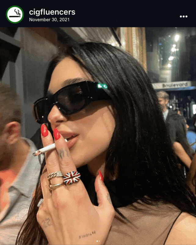 Screenshot of Dua Lipa with sunglasses on and a cigarette in here mouth, posted on the cigfluencers age-restricted Instagram page on November 20 2021.