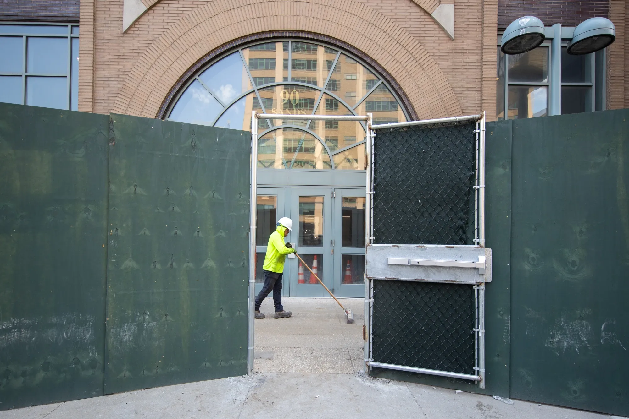 A&nbsp; worker sweeps outside a construction site in the Brooklyn borough of New York, U.S.
