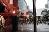 Pedestrians are reflected in a store window at the Sun Mall Ichibangai Arcade in Sendai, Miyagi Prefecture, Japan, on Friday, May 15, 2020. The Japanese government will evaluate next week if it can release Tokyo and 7 remaining prefectures from a state of emergency before the declaration ends on May 31, which could help the country re-activate more of its virus-battered economy.