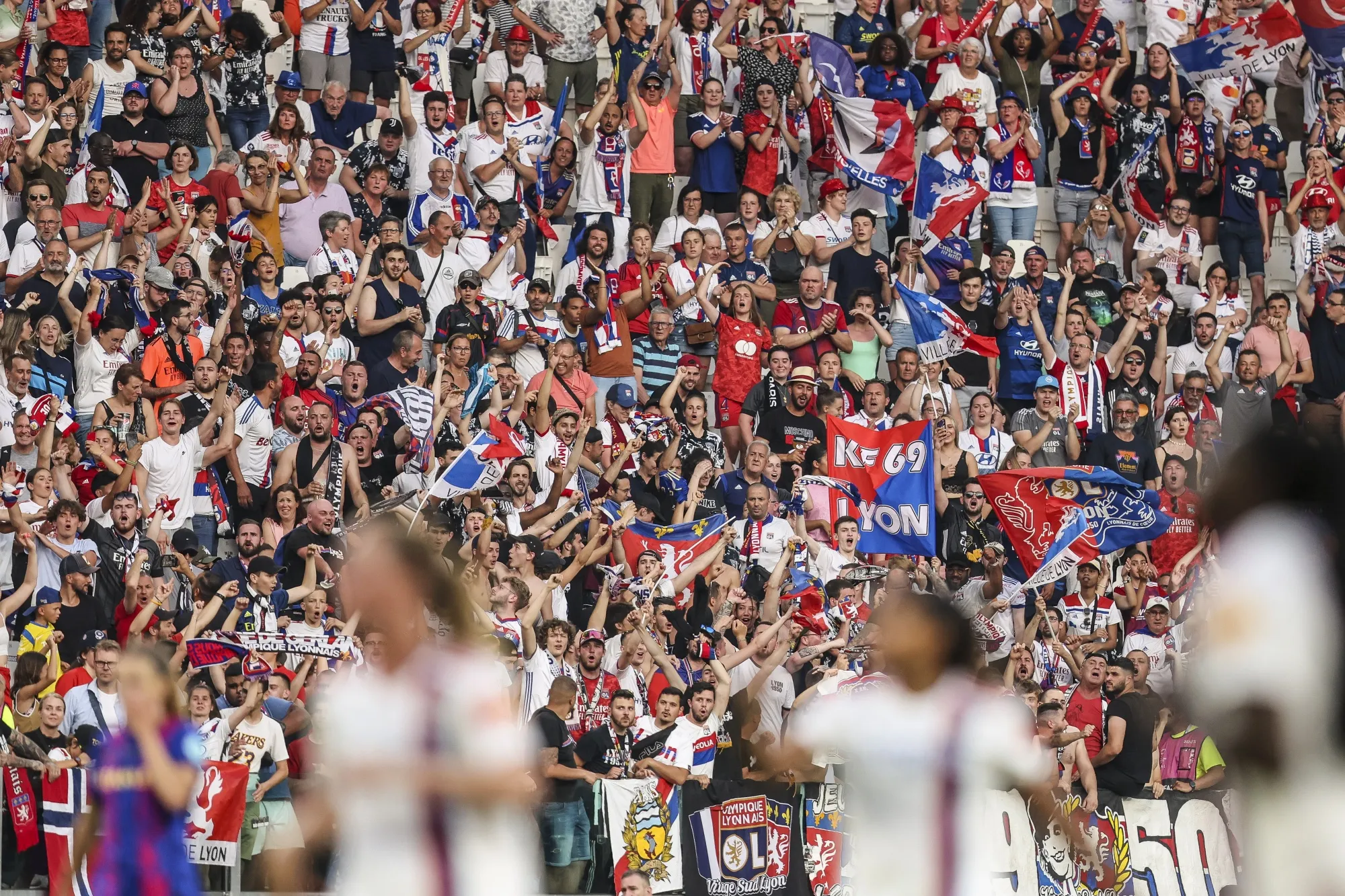 Fans of Olympique Lyonnais cheer during a match in Turin, Italy.