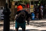 A visitor cools themselves at a water fountain at Ciutadella Park in Barcelona on Aug. 3, 2022.&nbsp;