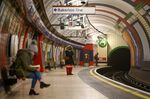 Commuters wait for a London Underground train at Piccadilly Circus station in London.