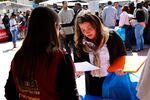 A woman receives information about job opportunities with Lowe's during the Fall Classic Hiring Spree event at Los Angeles City College in Los Angeles, on Oct. 10, 2013.
