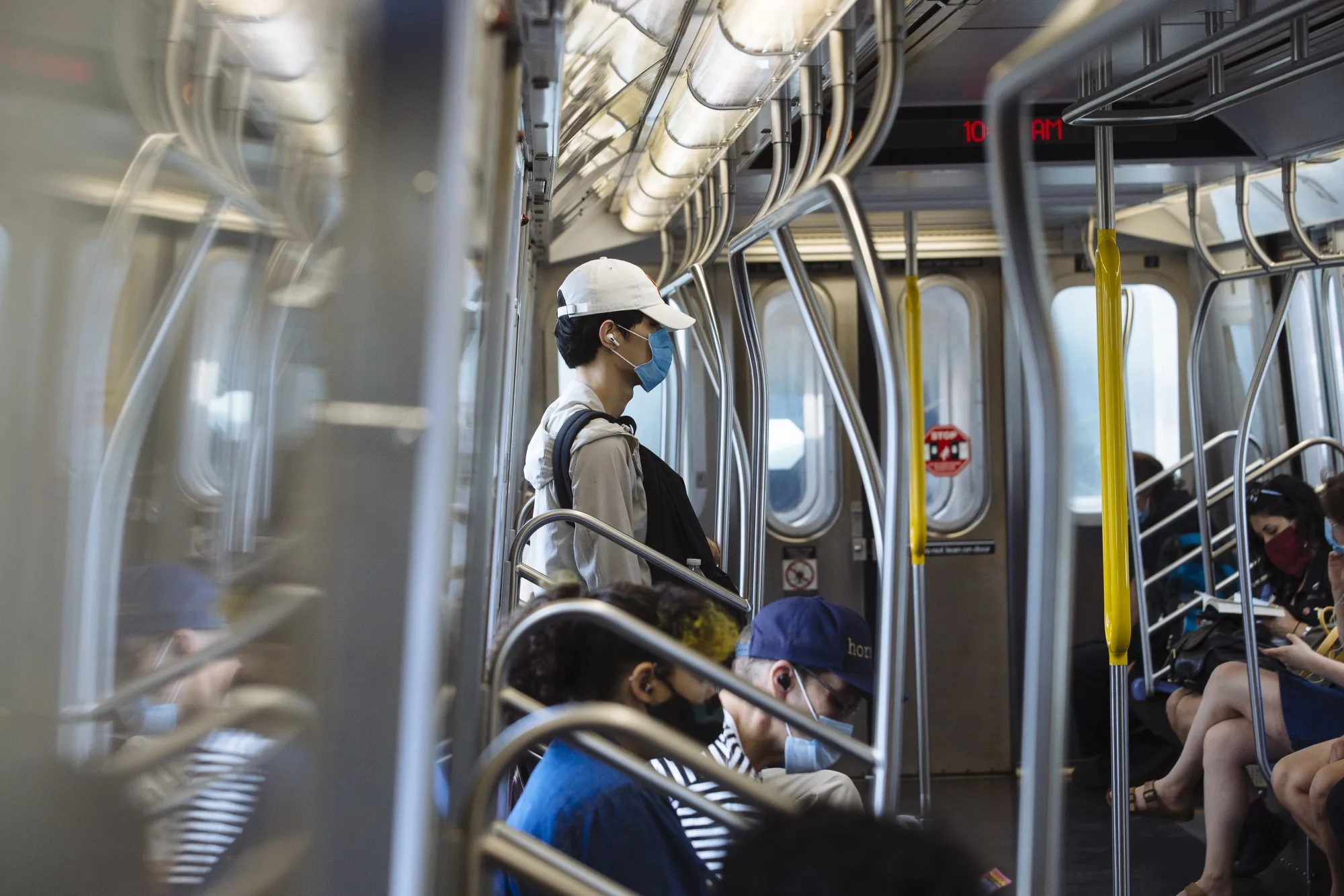 Passengers wearing protective masks ride the subway in New York on June 24.