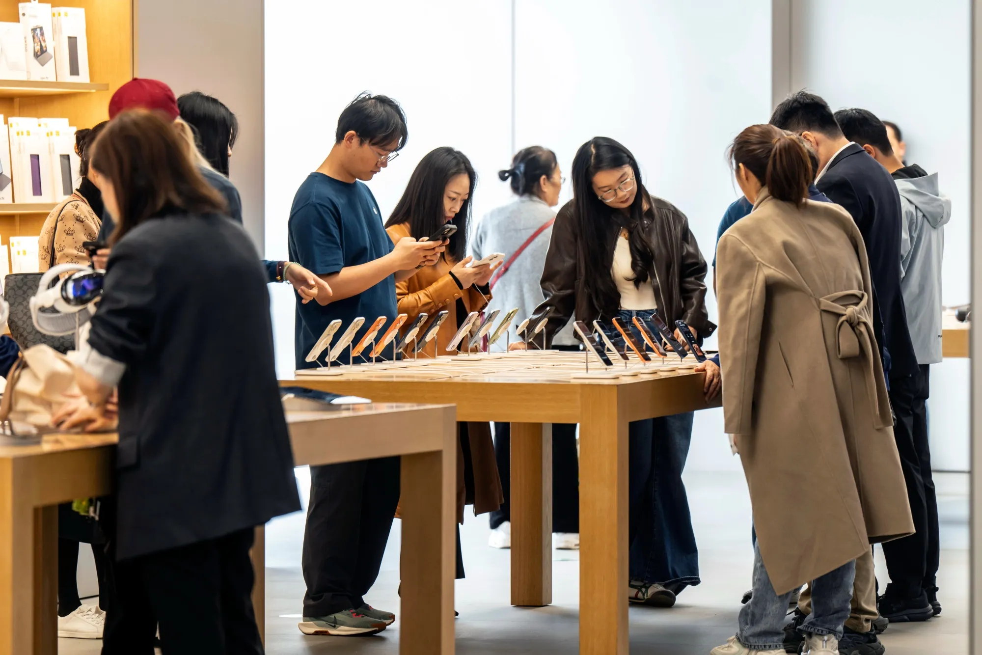 Customers look at Apple Inc. iPhone 17 series smartphones at one the company's stores&nbsp;in Shanghai.