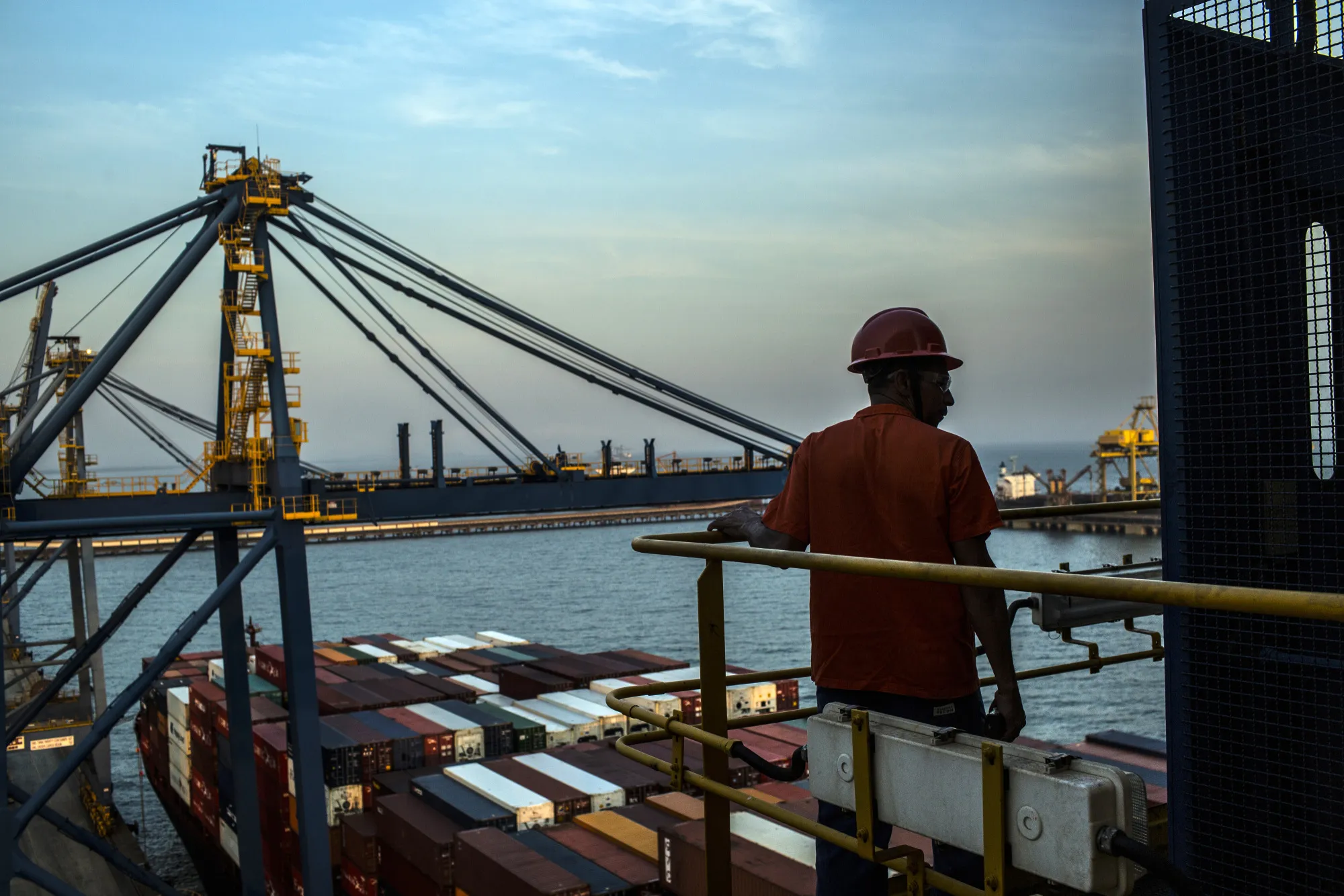 A worker waits to unload containers at the&nbsp;Sepetiba Tecon terminal inside the Port of Itaguai in Rio de Janeiro.