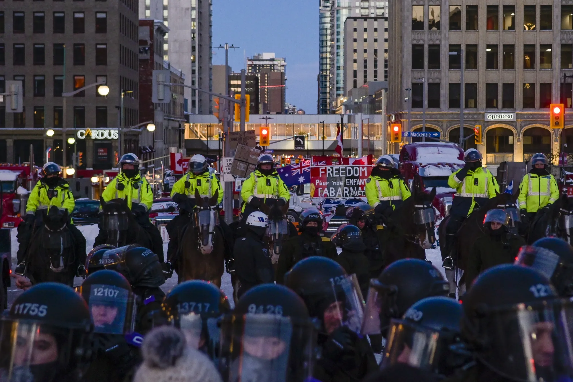 Horse-mounted law enforcement officers form a line during the “freedom convoy” demonstration in Ottawa on Feb. 18, 2022.