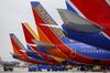 Southwest Airlines Co. Boeing Co. 737 aircraft sit on the tarmac at John Wayne Airport (SNA) in Santa Ana, California, U.S., on Thursday, April 14, 2016. Southwest Airlines Co. is scheduled to release earnings figures on April 21.