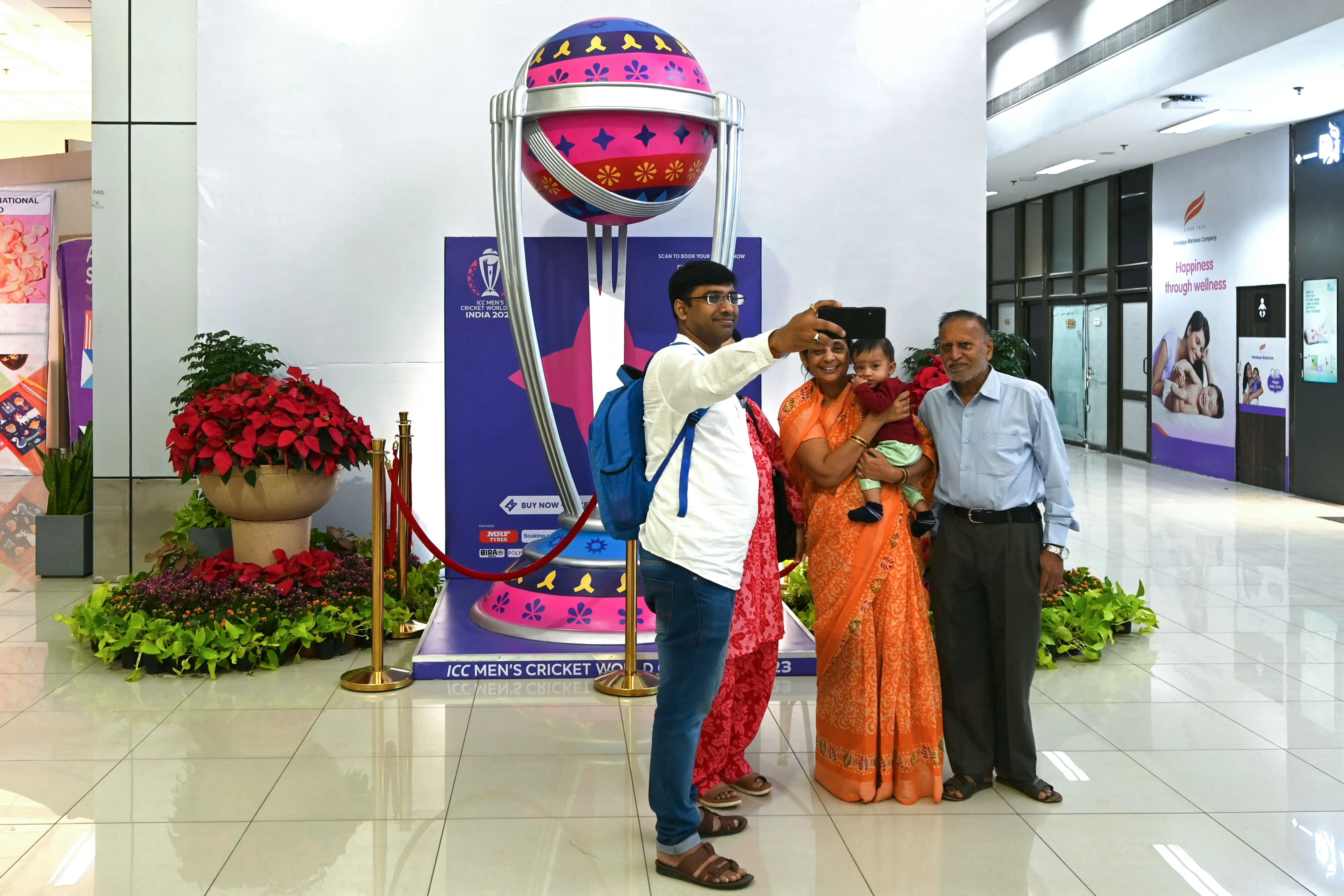 Visitors take selfie photographs at Sardar Vallabhbhai Patel International Airport, in Ahmedabad.