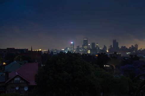 Darkness surrounds residential homes due to a blackout in Johannesburg.