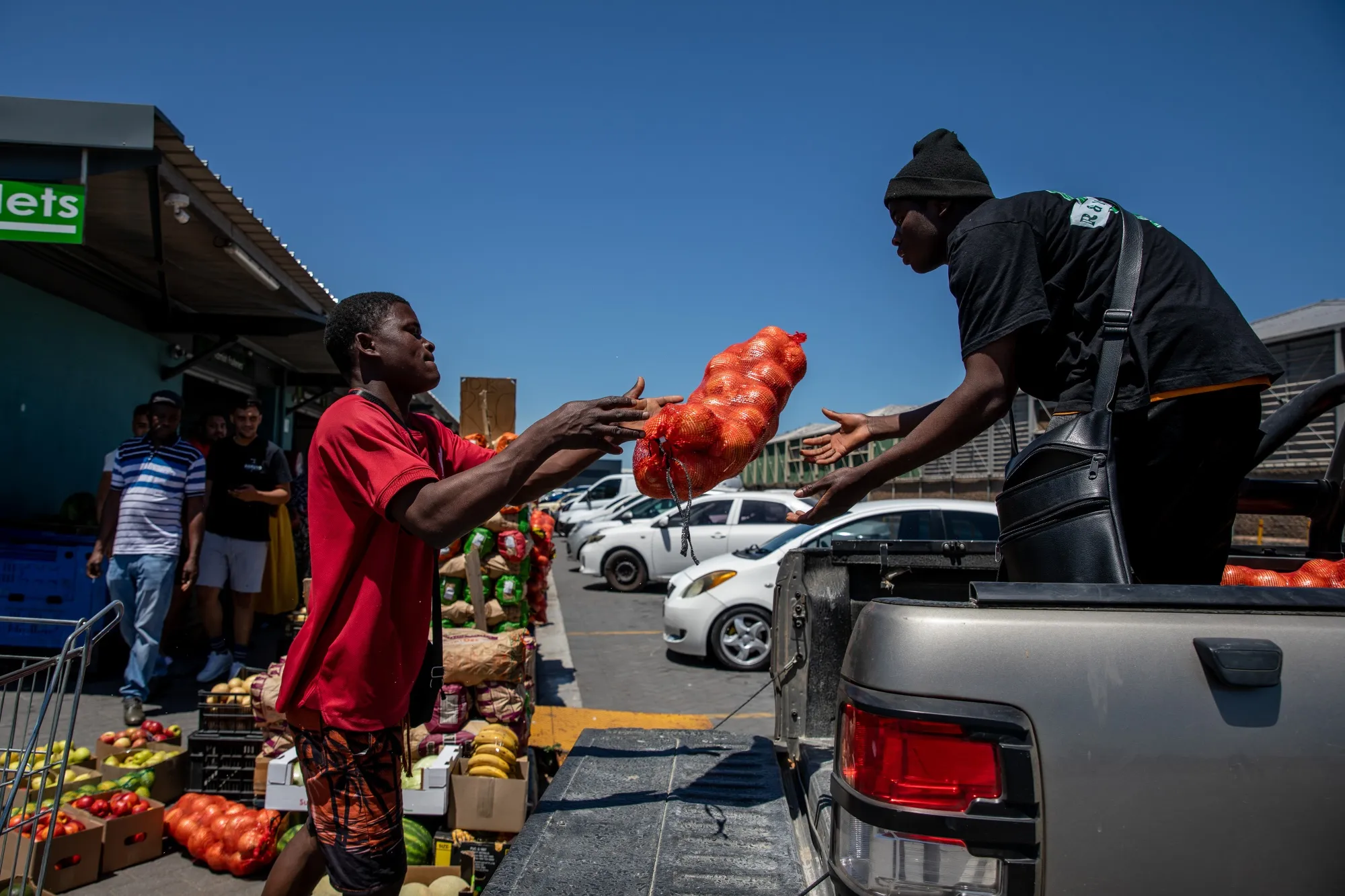 Shoppers load the boot of a car with groceries at a market in Cape Town.