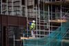 A builder works from scaffolding on the site of Wood Wharf, a development by the Canary Wharf Group, in the Canary Wharf business, financial & shopping district in London, U.K., on Monday, June 29, 2020. U.K. Prime Minister Boris Johnson promised a "big plan" to help the U.K. bounce back from the coronavirus pandemic, as the prime minister seeks to revive his struggling political mission with a major speech on Tuesday.