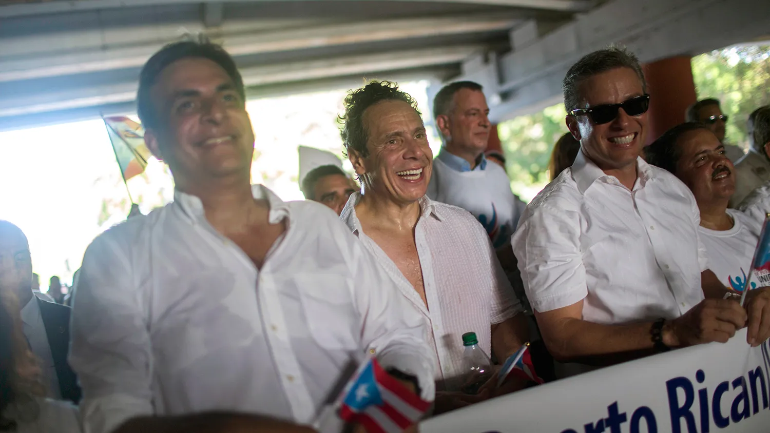 New York Governor Andrew Cuomo, center, and New York City Mayor Bill de Blasio, background, march during a protest in San Juan, Puerto Rico, on Nov. 5, 2015.
