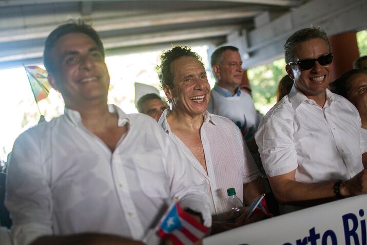 New York Governor Andrew Cuomo, center, and New York City Mayor Bill de Blasio, background, march during a protest in San Juan, Puerto Rico, on Nov. 5, 2015.

