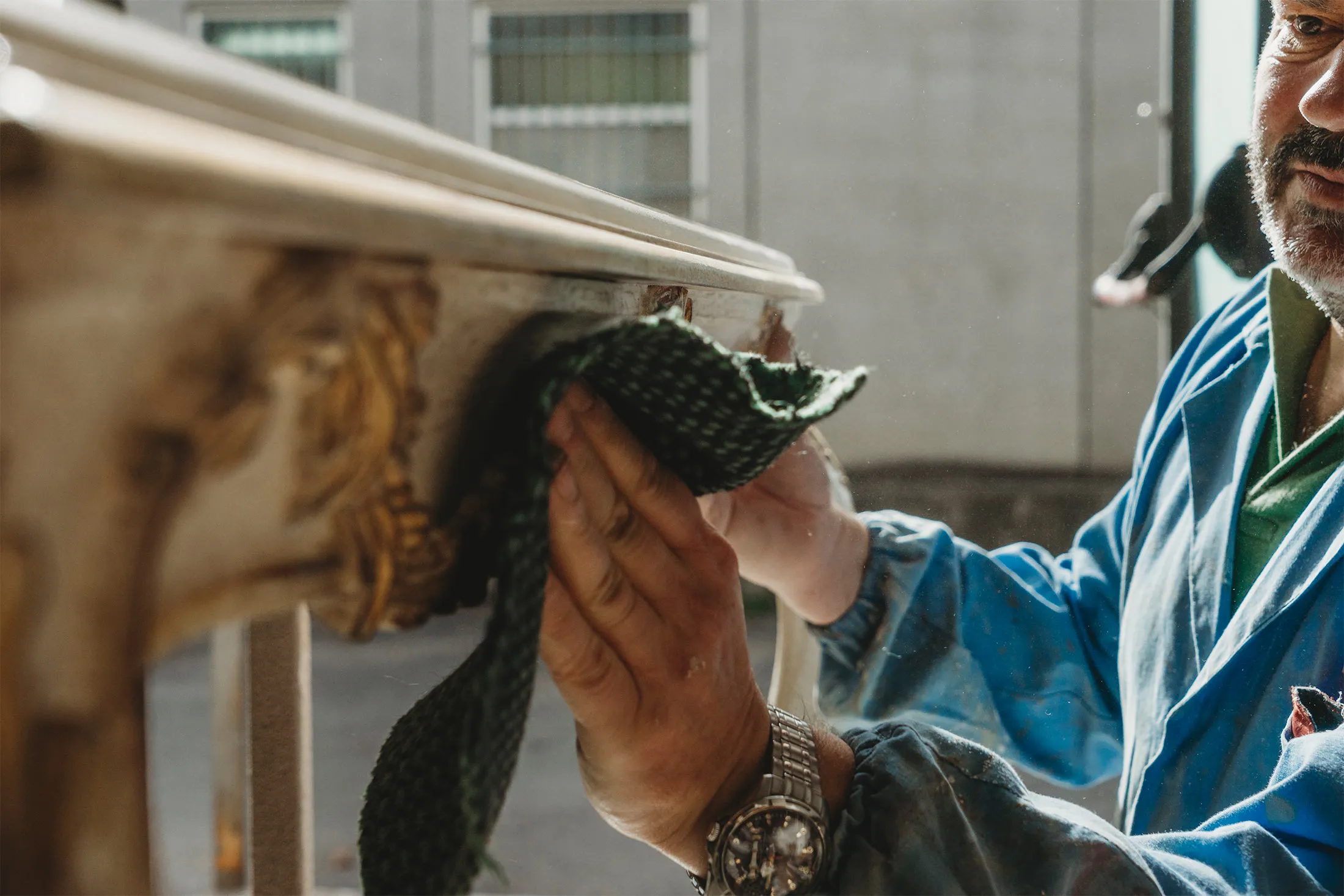 Carpenter polishing a restored table