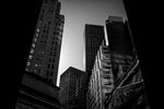 Buildings stand on Wall Street near the New York Stock Exchange (NYSE) in New York, U.S..