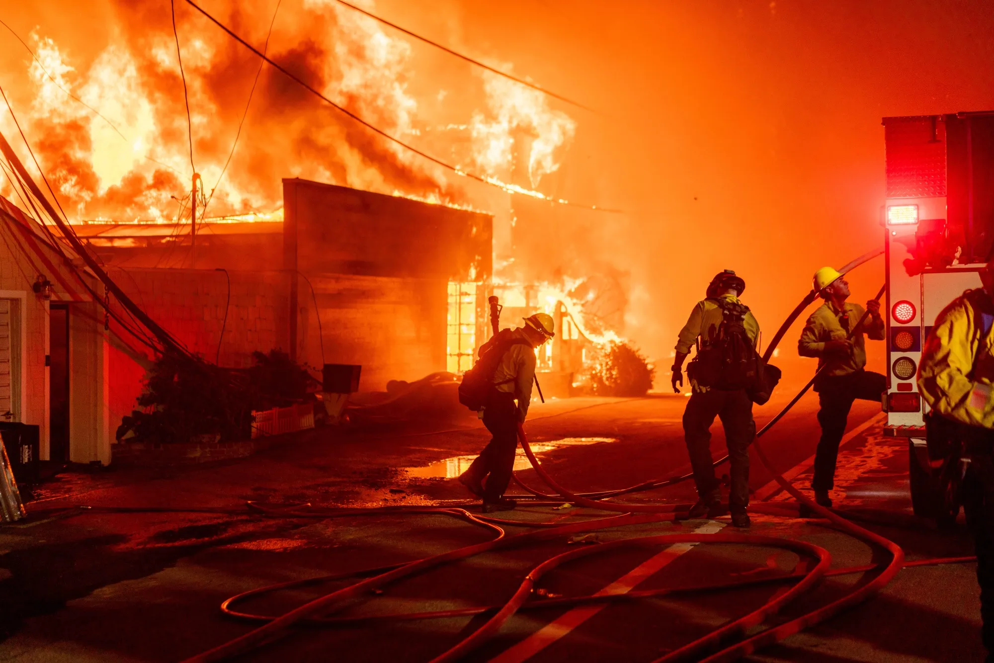 Firefighters battle flames during the Palisades Fire in Los Angeles in early 2025.