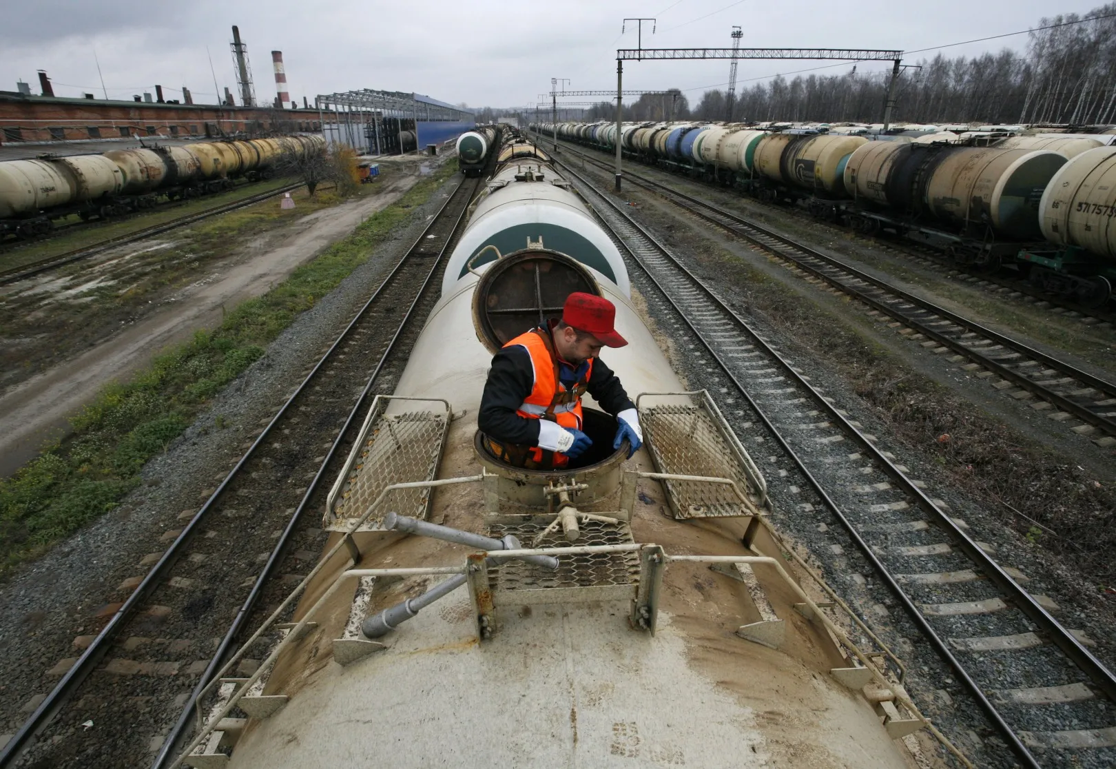A railway worker inspects a fuel wagon&nbsp;at the Zeletsyno train station near Nizhny Novgorod, Russia.