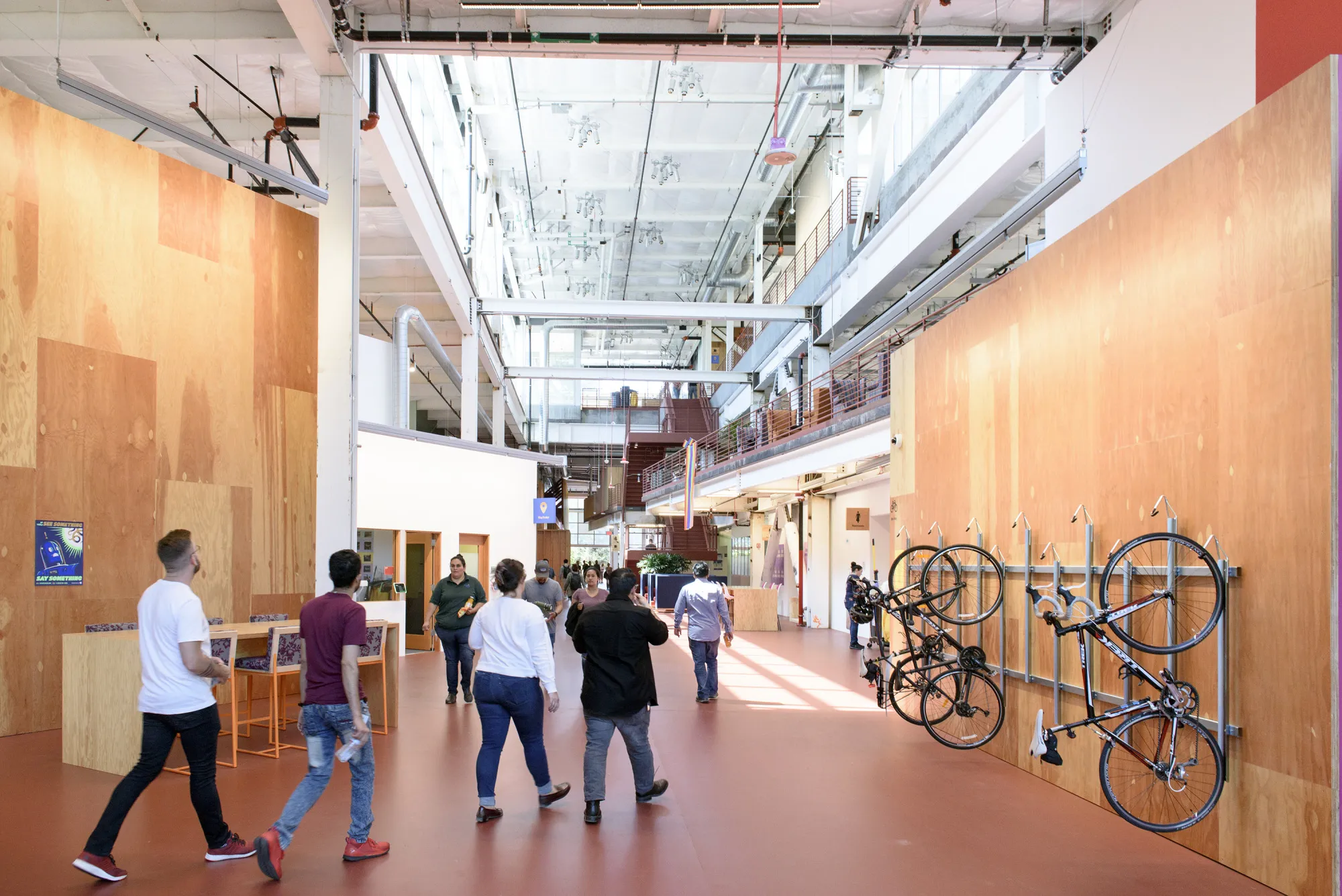 Employees walk past a wall bike rack at a&nbsp;Facebook Inc.&nbsp;office building in Menlo Park, California.
