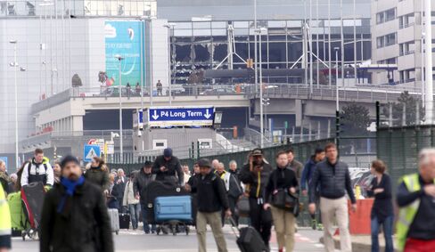 Passengers evacuate the airport.