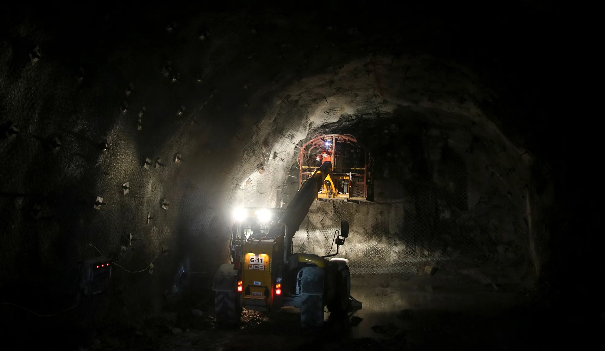 An employee stands on a lift inside Codelco’s Teniente mine.