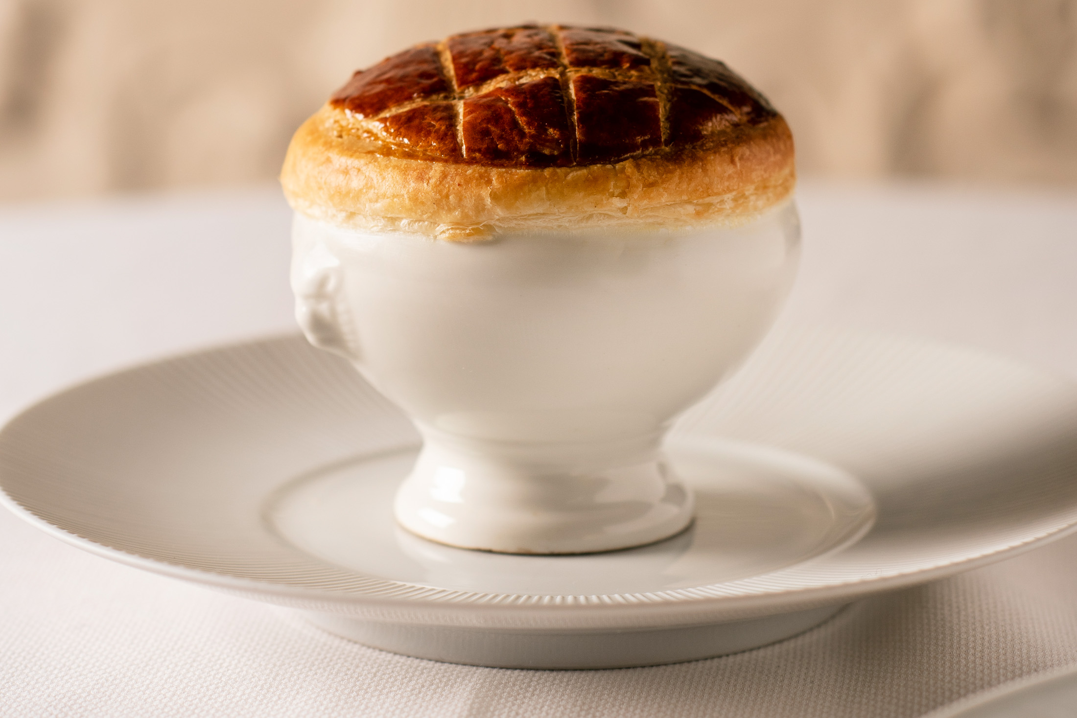 Underneath this pastry from Boulud&nbsp;is a decadent consommé with duck, savoy cabbage, and black truffle cream.