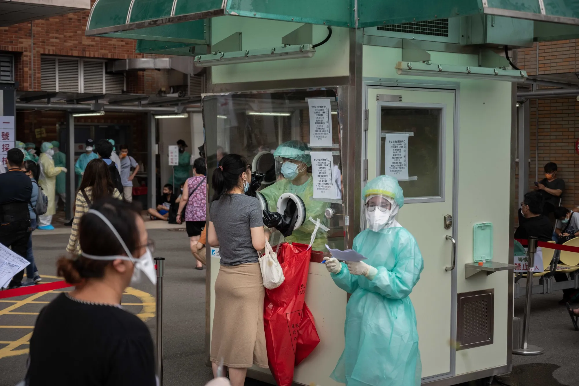 A healthcare worker collects a swab sample from a person at a temporary Covid-19 testing site in Taipei on May 17.