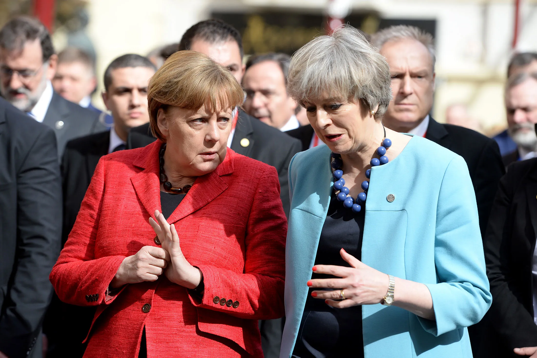 Germany's Chancellor Angela Merkel, left, speaks with British Prime Minister Theresa May on their way for a family picture during an European Union summit on Feb. 3, in Valletta, Malta.
