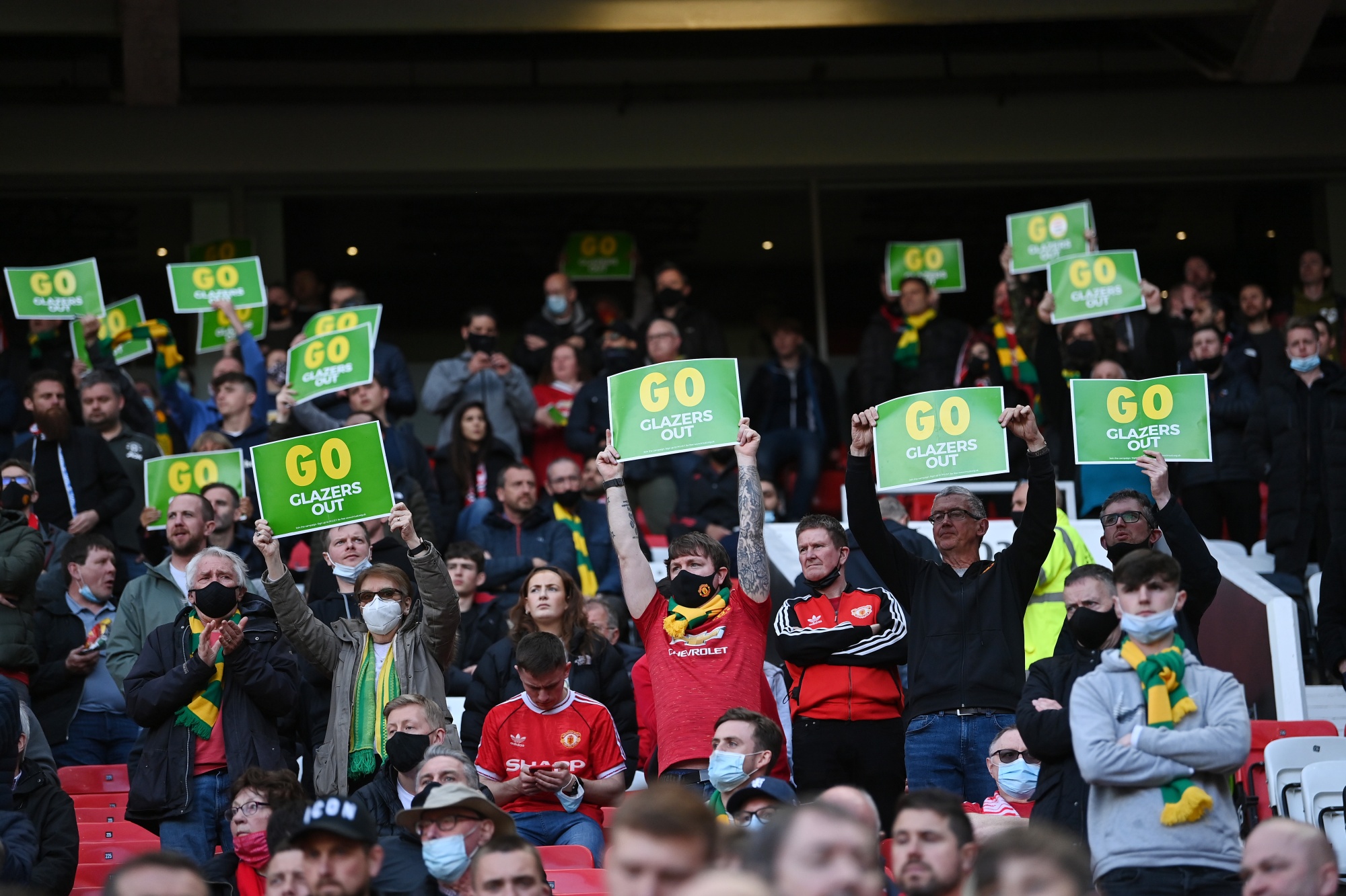Fans of Manchester United hold up &quot;GO Glazers Out&quot; signs during the Premier League match between Manchester United and Fulham at Old Trafford, in Manchester, U.K.,&nbsp;on May 18.