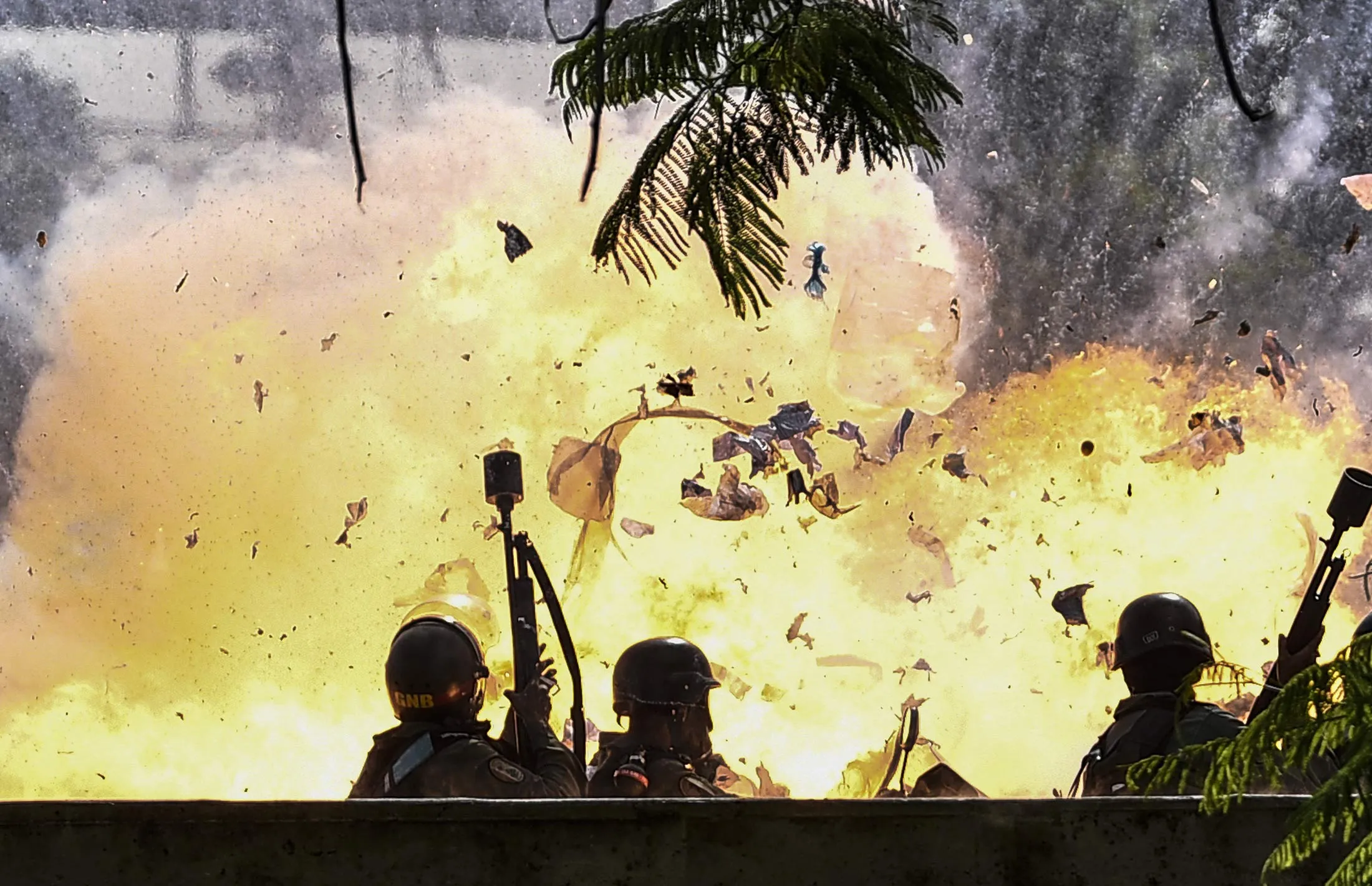 Members of the National Guard are caught up in a blast during protests in Caracas on July 10, 2017.
