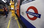 An employee walks past a London Underground train in the Golders Green district of London.