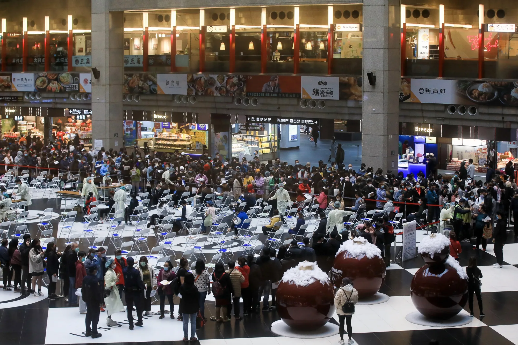 Members of the public wait in line at a vaccination facility administering the Moderna Covid-19 vaccine set up at Taipei Main Station in Taipei, Taiwan, on Jan. 17, 2022.&nbsp;