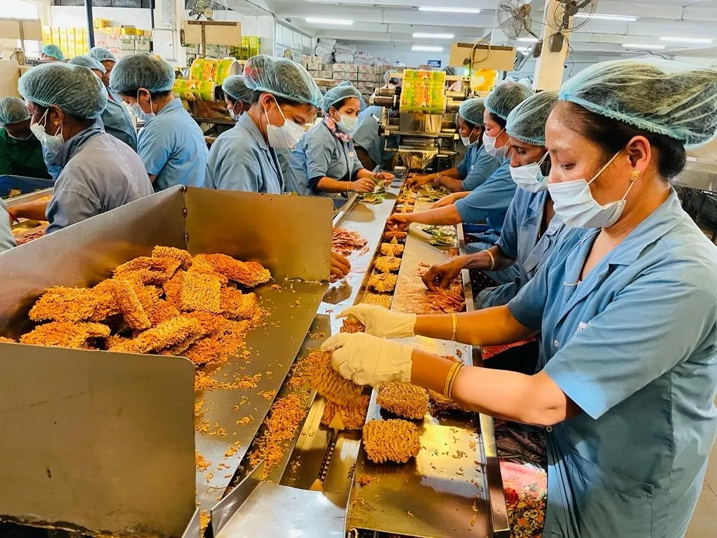 Workers on the Wai Wai instant noodles production line at CG Food’s Assam plant.