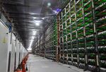 Racks of mining rigs at a cryptocurrency mining center.