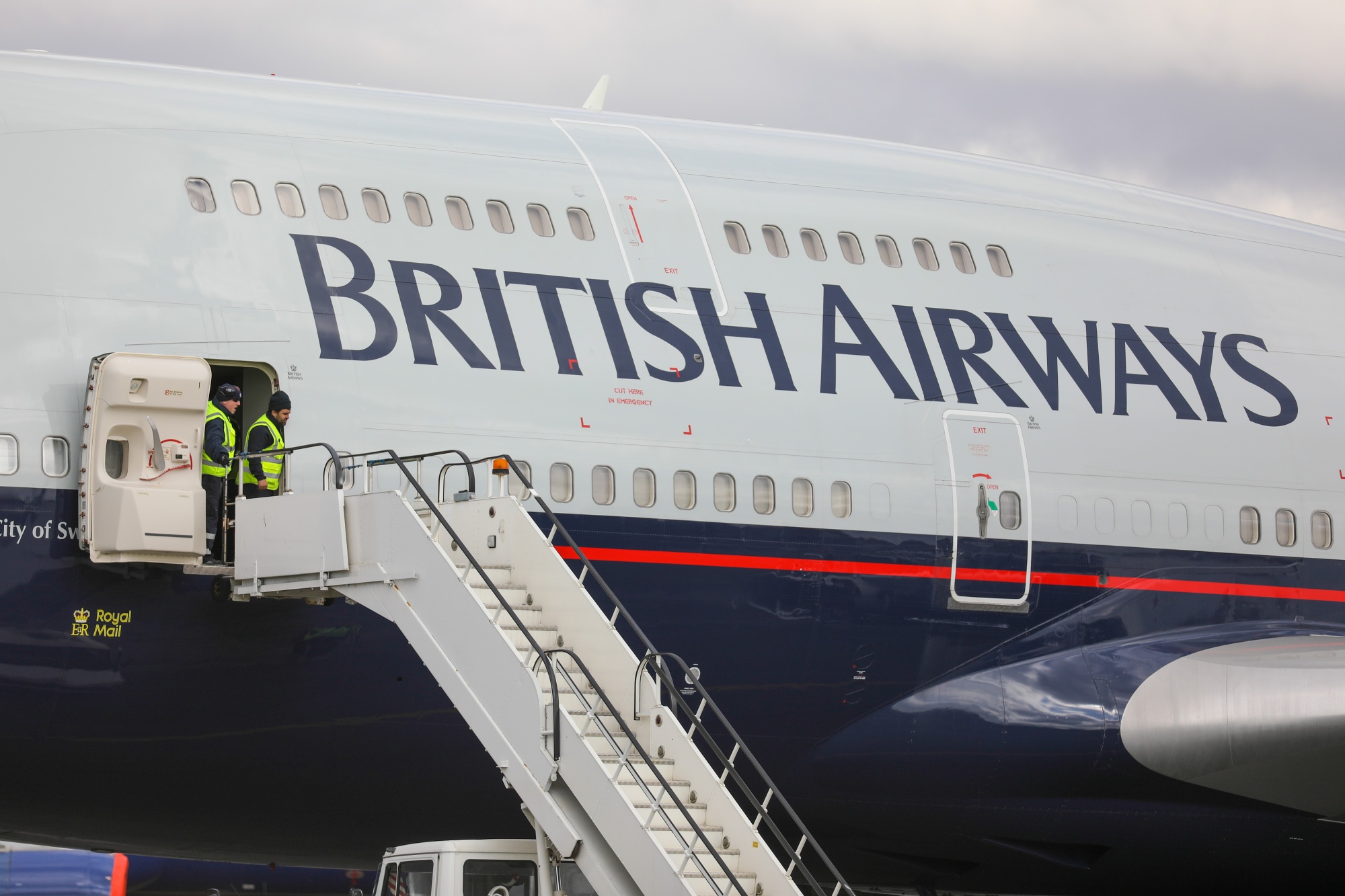Crew members prepare an air stair for a British Airways&nbsp;aircraft&nbsp;at Bournemouth Airport in Bournemouth.