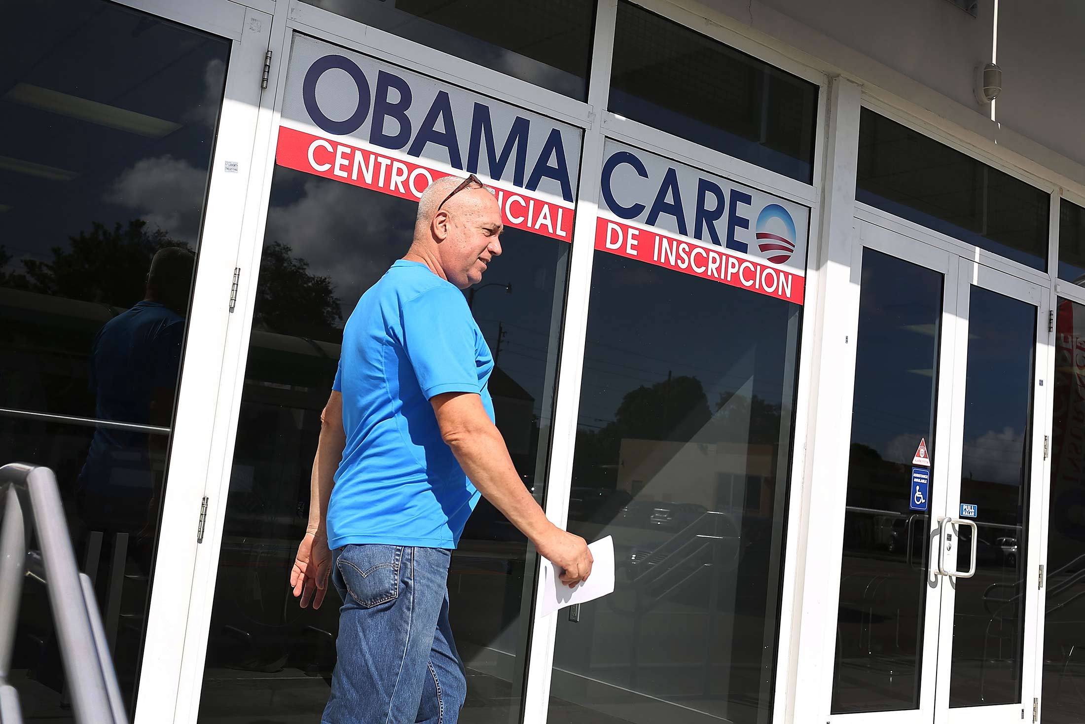 A man walks out of an insurance company office after shopping for a health plan under the Affordable Care Act, also known as Obamacare, on Dec. 15, 2015 in Miami, Florida.
