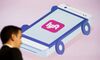 The Lfyt Inc. logo is seen as John Zimmer, co-founder and president of Lyft Inc., speaks during the Connected Car Expo ahead of the Los Angeles Auto Show in Los Angeles, California, U.S., on Tuesday, Nov. 17, 2015. Zimmer said the company is on track to hit $1 billion in annual revenue by this time next year.