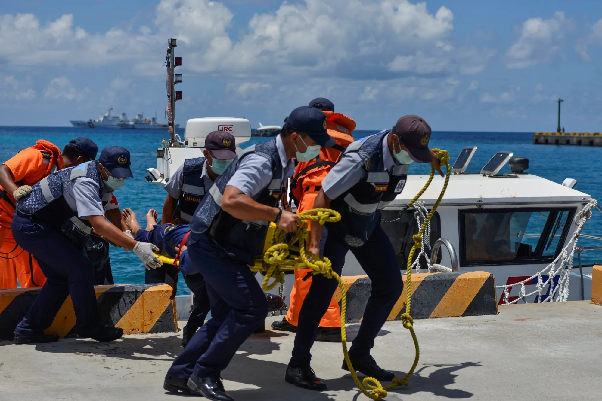 Members of Taiwan's coast guard carry a stretcher off a boat during in a drill in 2019. 