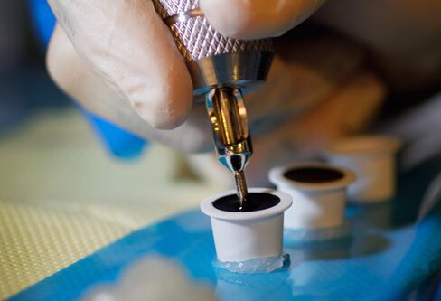 A tattoo needle dipped in ink.