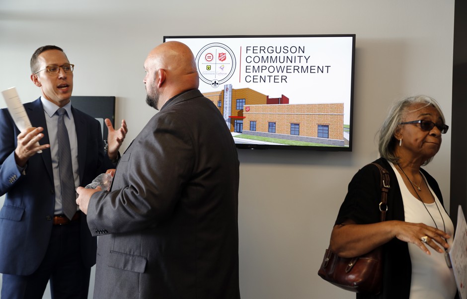 People gather in the lobby of a new community empowerment center in Ferguson, Missouri, following a dedication ceremony for the building in July. The $3 million center was built on the property where a QuikTrip convenience store was burned during rioting after a white officer fatally shot Michael Brown in August 2014.
