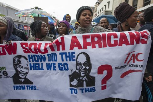 Protestors carry a banner during a march against corruption in Cape Town, on Wednesday, Sept. 30, 2015.