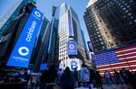 Monitors display Coinbase signage during the company's initial public offering (IPO) at the Nasdaq MarketSite in New York, U.S., on Wednesday, April 14, 2021. 