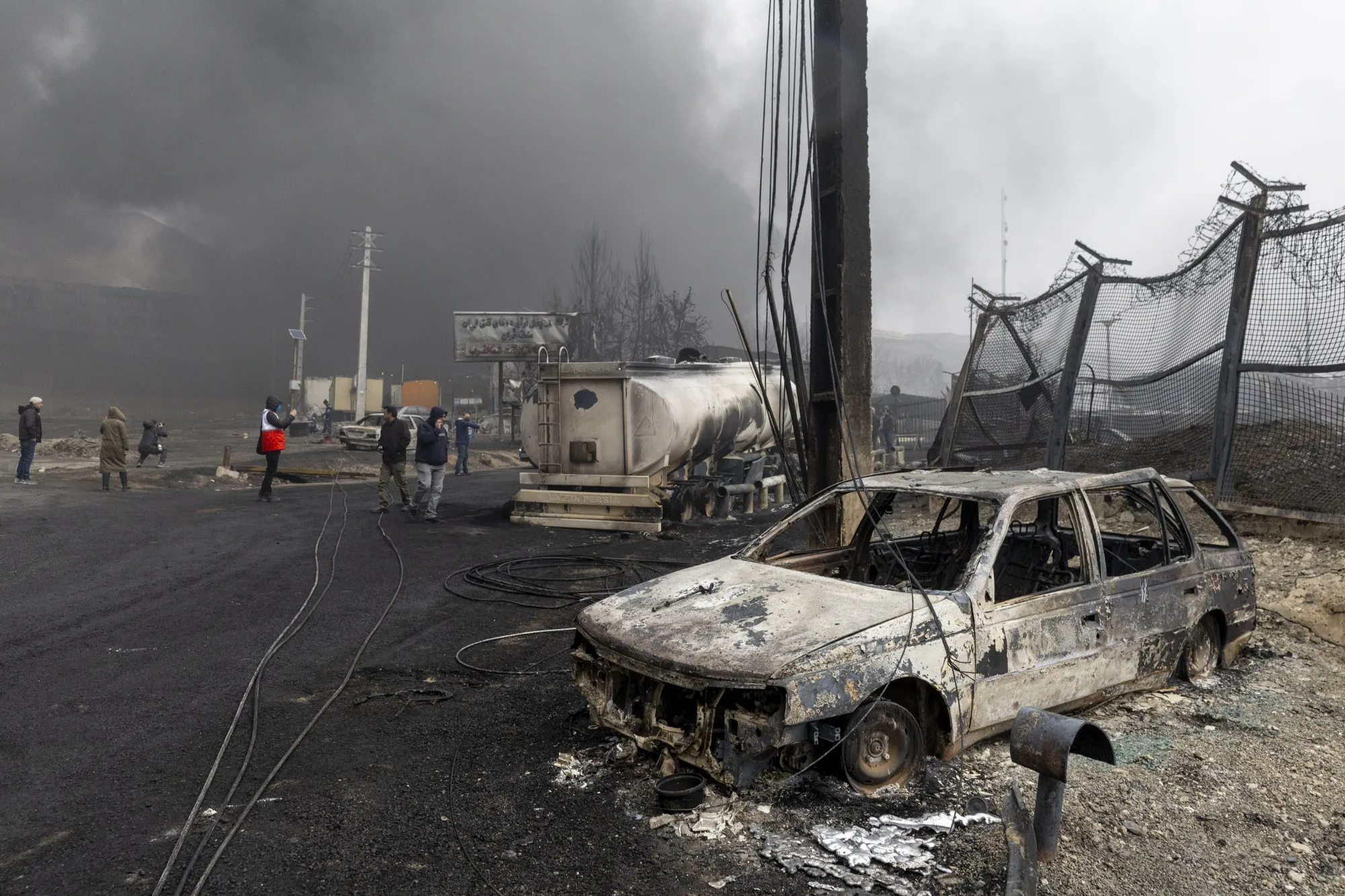 Remains of burnt vehicles following airstrikes on oil depots in Tehran, on March 8.