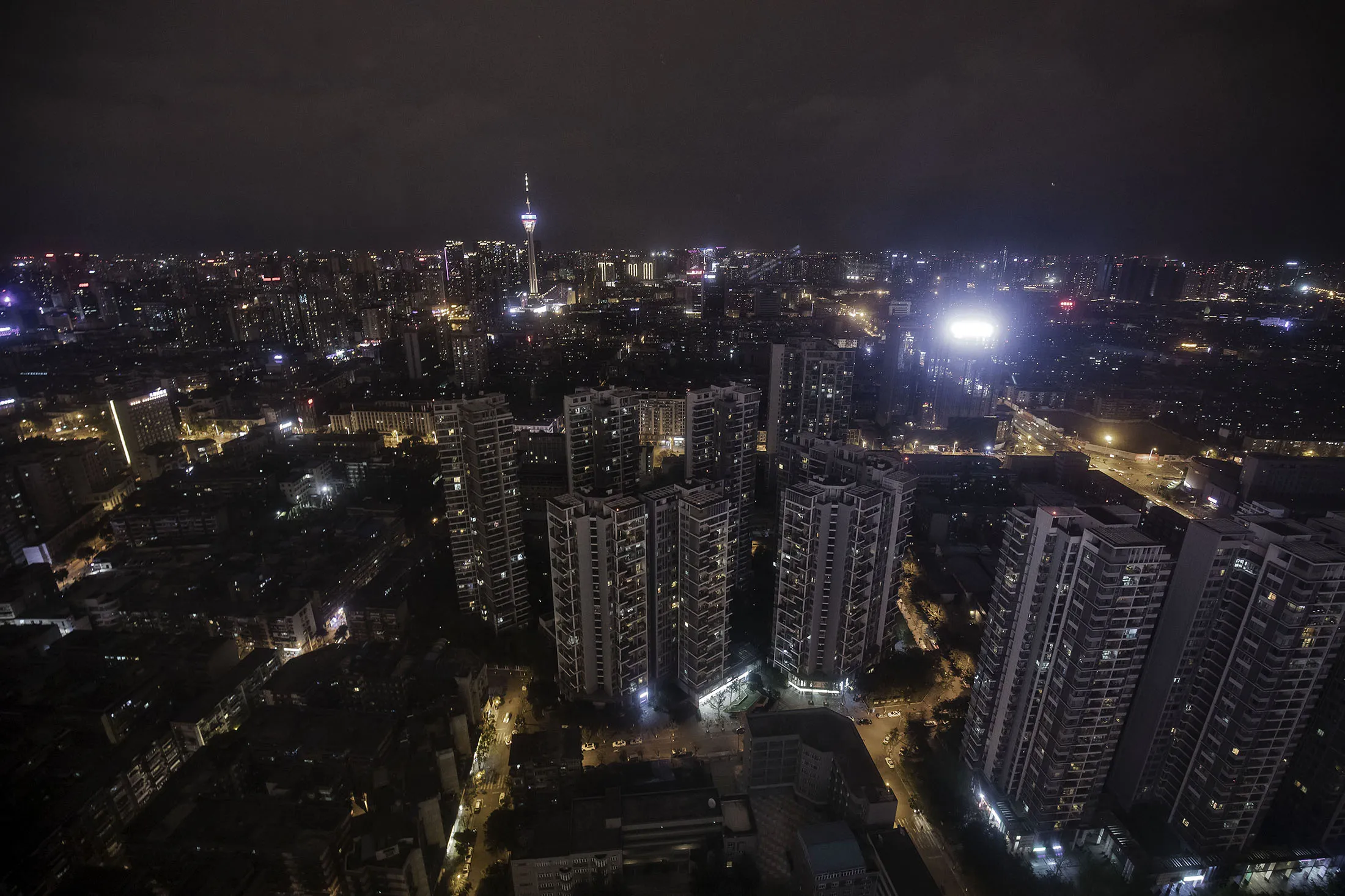 The West Pearl Tower, background left, stands among residential and commercial buildings illuminated at night in Chengdu, China, on Sunday, April 9, 2017. Sparing China from the currency-manipulator label is the latest indication that Trump's rhetoric on trade as the Republican candidate last year was harsher than the policies he's establishing as president.
