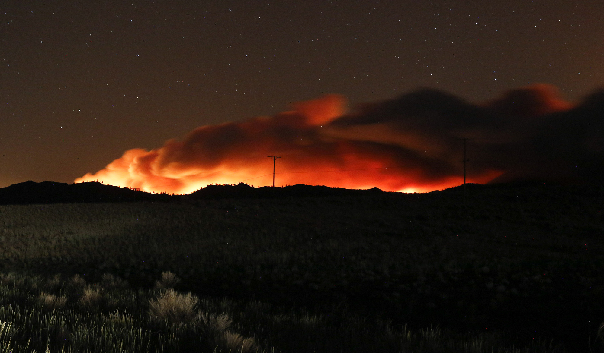 Flames and smoke rise from the Beckwourth Complex Fire in Beckwourth, California, on July 9.