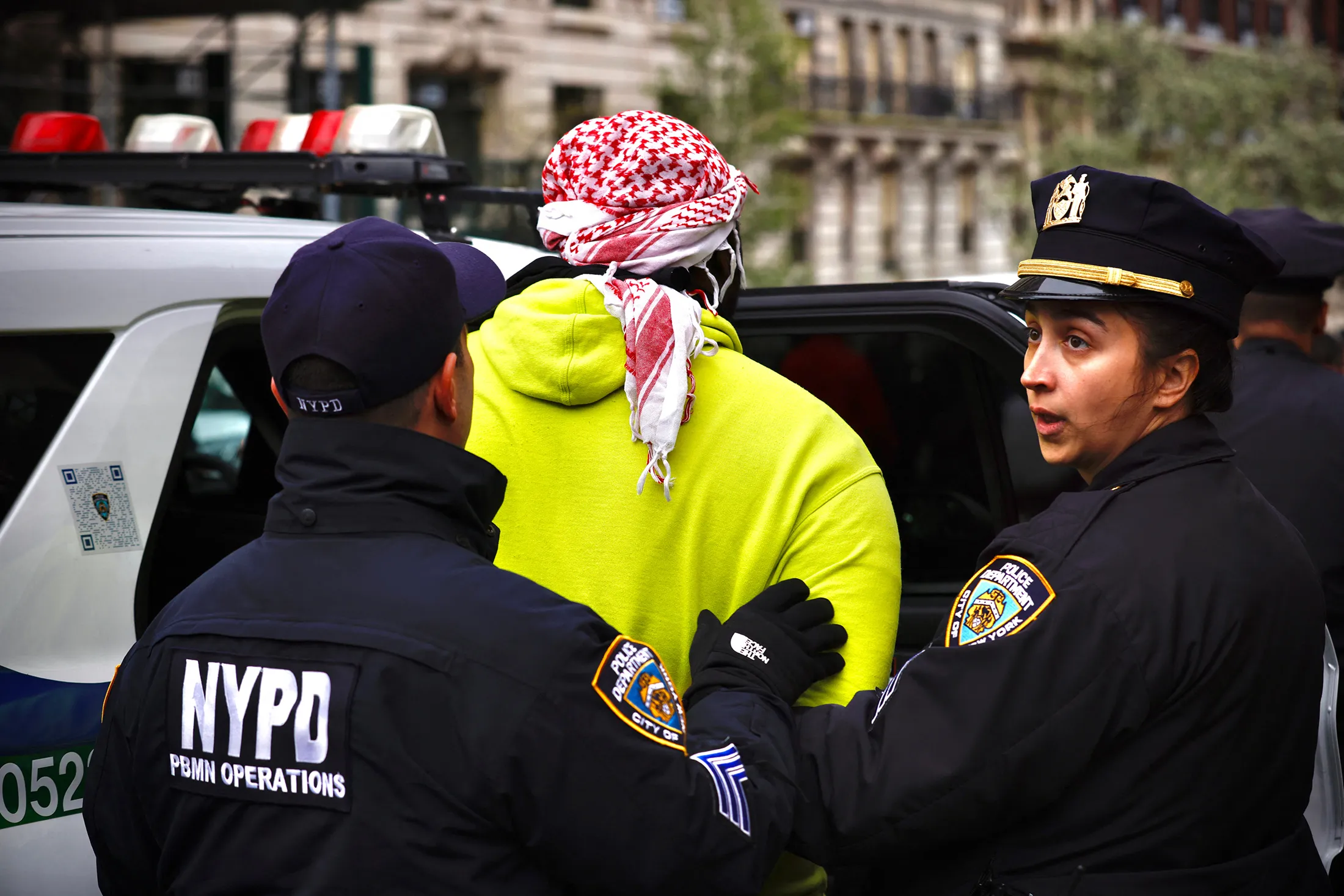 NYPD officers detain a person outside Columbia University in New York on April 18.