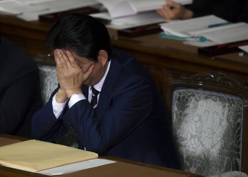 両手で顔を覆う安倍首相